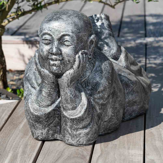 Grey weathered-finish reclining monk statue