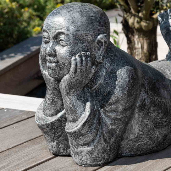 Grey weathered-finish reclining monk statue